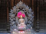 Kathmandu Patan Golden Temple 17 Swayambhu Chaitya Buddha Statue A small Buddha statue is one of many surrounding the outside of the Swayambhu Chaitya in the Golden Temple in Patan.